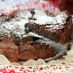 a chocolate cake with powdered sugar on top