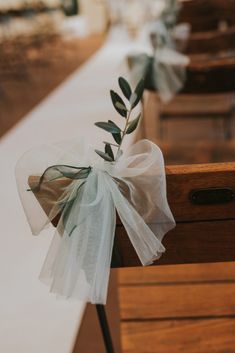 an olive branch is tied to the back of a church pew with organ - bow