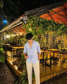 a man standing in front of tables covered with plants