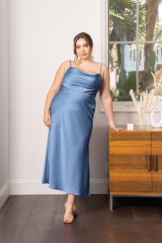 This stunning cowl neck slip dress is chic, comfortable, and flattering on all body types. Full length satin dress with a twisted halter neckline. Fully lined with built-in cups for extra support. Model is 5’8.5" & wearing a size 14 Fit: True to size. *Our gowns may have a manufacturer's variation of +/- 1/2 inch in dress or length measurements. Camera resolution and monitors may cause colors to vary slightly between the photos and the actual fabric. Colors are subject to the actual dress(es) yo Cowl Neck Slip Dress, Dress Satin, Halter Neckline, Satin Dress, Rumi, Measurement Length, Steel Blue, Satin Dresses, Cowl Neck