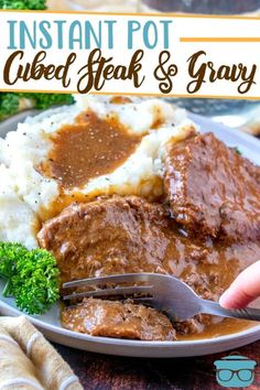 a close up of a plate of food with meat and gravy on it