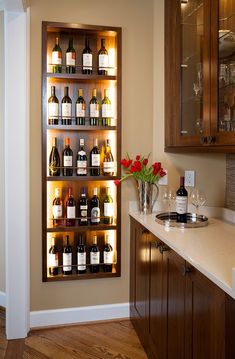 a wine rack filled with lots of bottles on top of a counter next to a sink