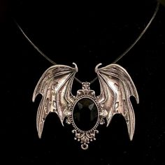 Please read descriptions thoroughly for sizes and materials. This is an eye catching large silver metal pendant featuring silver bat wings, with a black faceted glass gem in the center. It is hung from a black faux leather woven waxed cord that is 19 1/2" long, with silver chain and a silver lobster claw clasp. * Also available on a 18" 20" 24" or 30" silver stainless steel snake chain.  The pendant is just over 3" wide and just under  2 1/2" long. Make sure to check out my shop for more hair pins, jewelry, accessories, and all sorts of fun stuff! Bat Necklace, Large Black Bat, Goth Necklace, Gothic Necklace, Wing Necklace, Bat Wing, Silver Black Bat, Vampire Jewelry, Bat Jewelry, Vampire Necklace Please note: I am not responsible for any items lost or damaged in the mail. Please double ch Vampire Necklace, Vampire Jewelry, Bat Jewelry, Bat Necklace, Goth Necklace, Bat Wing, Gothic Necklace, Wing Necklace, Black Bat