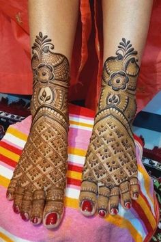 two feet with henna tattoos on them