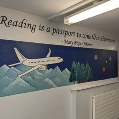 an airplane painted on the side of a building with words reading reading is a passport to countless