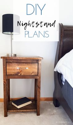 a wooden night stand with a book on it next to a lamp and a bed