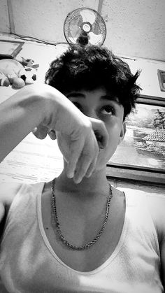 a young man pointing at the camera with his finger in black and white photo,