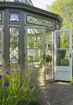 a green house with lots of windows and plants