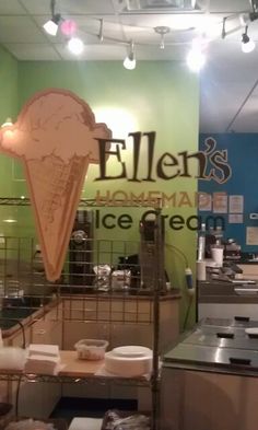 an ice cream shop with green walls and signs on the wall that say ellen's