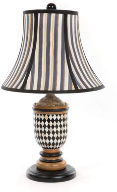 a table lamp with a black and white checkerboard shade on the base,