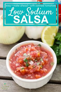 salsa in a white bowl with cilantro, lime and garlic on the side