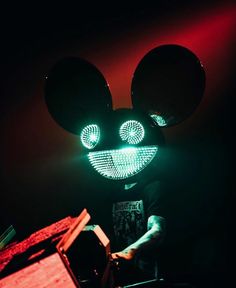 a mickey mouse head with glowing eyes and ears