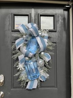 a blue and white christmas wreath on the front door