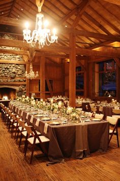 a dining room with tables and chairs set up for a formal function in front of a fire place