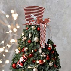 a small christmas tree decorated with red and white ornaments