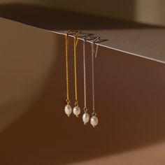 It’s as easy as pie to throw on our Pearl Threader Earrings and put an outfit together. Glamorous and dainty, these dangling charm earrings are minimalistic and perfectly stack with other earrings in your collection. Material: High Quality Solid 925 Sterling Silver Finish: 18K Gold ∙ Sterling Silver Featuring ~0.7mm Thick Chain Earrings ~60mm in Length, with a ~5.5x4.5mm Pearl Charm Sold as a pair Part of our Pearl Collection Model showcases a glamorous, event-ready look featuring Pearl Station Chic Dangle Threader Earrings Gift, Minimalist Single Pearl Drop Earring, Minimalist Single Pearl Earring For Everyday Elegance, Minimalist Pearl Drop Earrings For Everyday Elegance, Dainty Long Drop Pearl Earrings For Everyday, Minimalist Everyday Pearl Drop Earrings, Everyday Dainty Dangle Linear Earrings, Elegant Everyday Jewelry With Dangling Charms, Classic Single Dangle Threader Earring