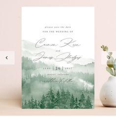 a wedding card with watercolor trees on it