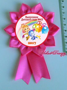 a pink ribbon with cartoon characters on it