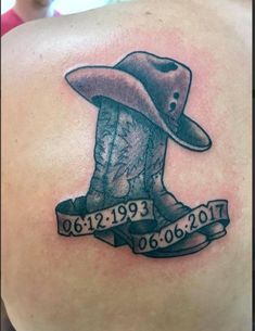 the back of a man's shoulder with a cowboy hat and ribbon around it