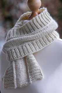 a white knitted scarf on top of a mannequin's dummy head