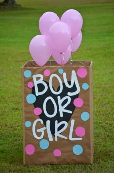 a box with some balloons in it that says boy or girl