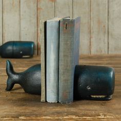 two bookends made to look like whales are sitting next to each other