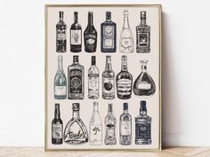 an art print of liquor bottles in black and white, on a wooden floor next to a wall