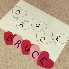 paper hearts with the word bruce written on them next to a piece of paper that says bruce