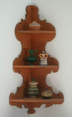 a wooden shelf with three shelves on it