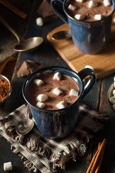 two mugs filled with hot chocolate and marshmallows