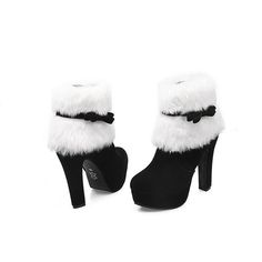 a pair of black and white high heeled shoes with fur on the upper part