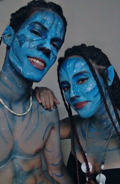 two people with blue paint on their faces