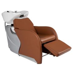 a brown and white reclining chair sitting on top of a white floor next to a sink