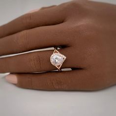 a woman's hand with a diamond ring on it