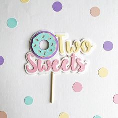 there is a cake topper that says two sweets and a donut on it