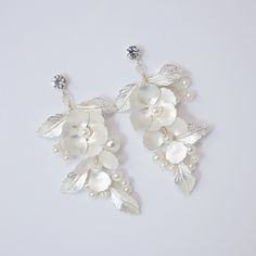 New to our Millennium Bride Collection These Beautiful Romantic Swarovski Flower Petals Crystal Earrings are made of very fine quality of Swarovski Crystals, Pearl, Rhinestones and beautifully made metal flower and leaves for your special day! Even we have hard time taking pictures because of their shine 😄 so we want to shine our brides on their special days. The material used in these earrings are free from Lead, Nickel, Cadmium so it will not give you any skin irritation and environment frien Bridal Earrings Statement, Bride Collection, Bridal Statement Earrings, Flower And Leaves, Crystal Bridal Earrings, Metal Flower, Jewelry Bridal, Back Jewelry, Skin Irritation