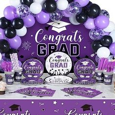 graduation party decorations with balloons and confetti in purple, black and white colors