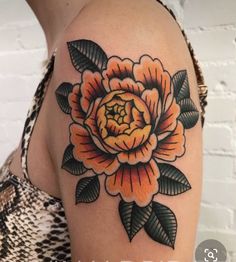 a woman's arm with an orange flower tattoo on the left side of her arm