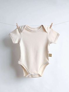 This buttery-soft short sleeve baby onesie is a must in any baby's wardrobe. It's perfect for warmer days or as a baby-safe bottom layer underneath a sweater, vest or a jacket. Envelope neck opening with extra neck space Can be pulled down without going over your baby's head Extra belly space so your baby can feel extra comfortable Made with certified 100% organic cotton OEKO-TEX Standard 100 certified snap buttons Allergy-friendly Size range: 21-33". Runs true to its size. Not sure which size t Baby First Outfit, Gender Neutral Baby Shower Gifts, Baby Hospital Outfit, Baby Layette Set, Organic Cotton Baby Clothes, Short Sleeve Kimono, Baby Layette, Hospital Outfit, Baby Hospital