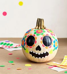 a decorated pumpkin sitting on top of a table