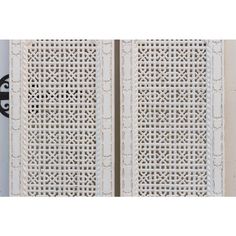 two white doors with intricate designs on them