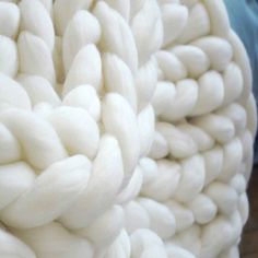 closeup of white yarn with blue background