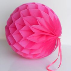 a pink paper ball on a white table