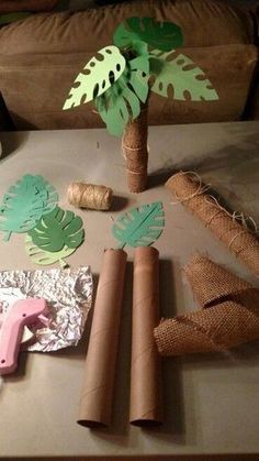 the table is set up with paper, scissors and other crafting supplies on it