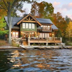 a house sitting on top of a lake next to a forest