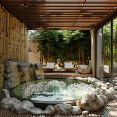 an outdoor hot tub surrounded by rocks and water features bamboo walls, wood flooring, and seating area