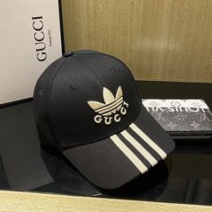 SHOP MORE LUXURY PRODUCTS HERE Description Gucci x Adidas Baseball Hat Black GG Hat Part of the adidas x Gucci collection, this baseball hat features Gucci Trefoil embroidery. Emblematic HouseÃƒÂ¯Ã‚Â¿Ã‚Â½ÃƒÂ¯Ã‚Â¿Ã‚Â½ÃƒÂ¯Ã‚Â¿Ã‚Â½ÃƒÂ¯Ã‚Â¿Ã‚Â½ÃƒÂ¯Ã‚Â¿Ã‚Â½ÃƒÂ¯Ã‚Â¿Ã‚Â½ÃƒÂ¯Ã‚Â¿Ã‚Â½ÃƒÂ¯Ã‚Â¿Ã‚Â½s motifs mix with those of the historic sportswear brand adidas. The collection sees both heritages encoded in a trio of lines, where adidas and Gucci combine archival emblems. Creative Director, Alessandro Miche Adidas Logo Hat With Curved Visor For Streetwear, Casual Adidas Hat With Curved Visor, Adidas Logo Snapback Baseball Cap, Adidas Logo Baseball Cap For Streetwear, Adidas Logo Adjustable Snapback Baseball Cap, Adidas Logo Baseball Cap For Sports Events, Adidas Logo Baseball Cap With Curved Visor For Streetwear, Casual Adidas Logo Cap, Adidas Logo Sporty Snapback Baseball Cap