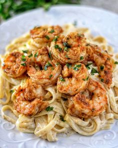 pasta with shrimp and parsley on white plate