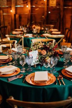 the table is set with plates and place settings