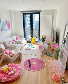 a living room filled with lots of furniture and decor on top of a hard wood floor